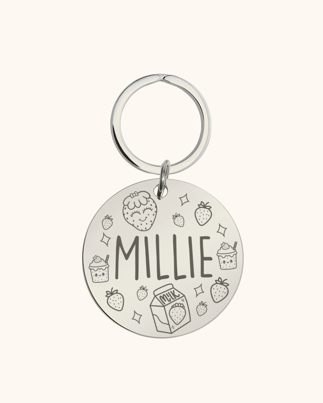 Silver pet tag with 'Millie' engraved on a white background