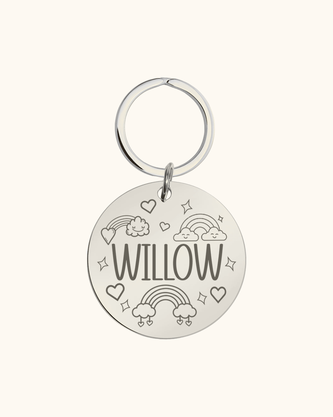 Silver pet tag with 'WILLOW' text and decorative elements on a white background