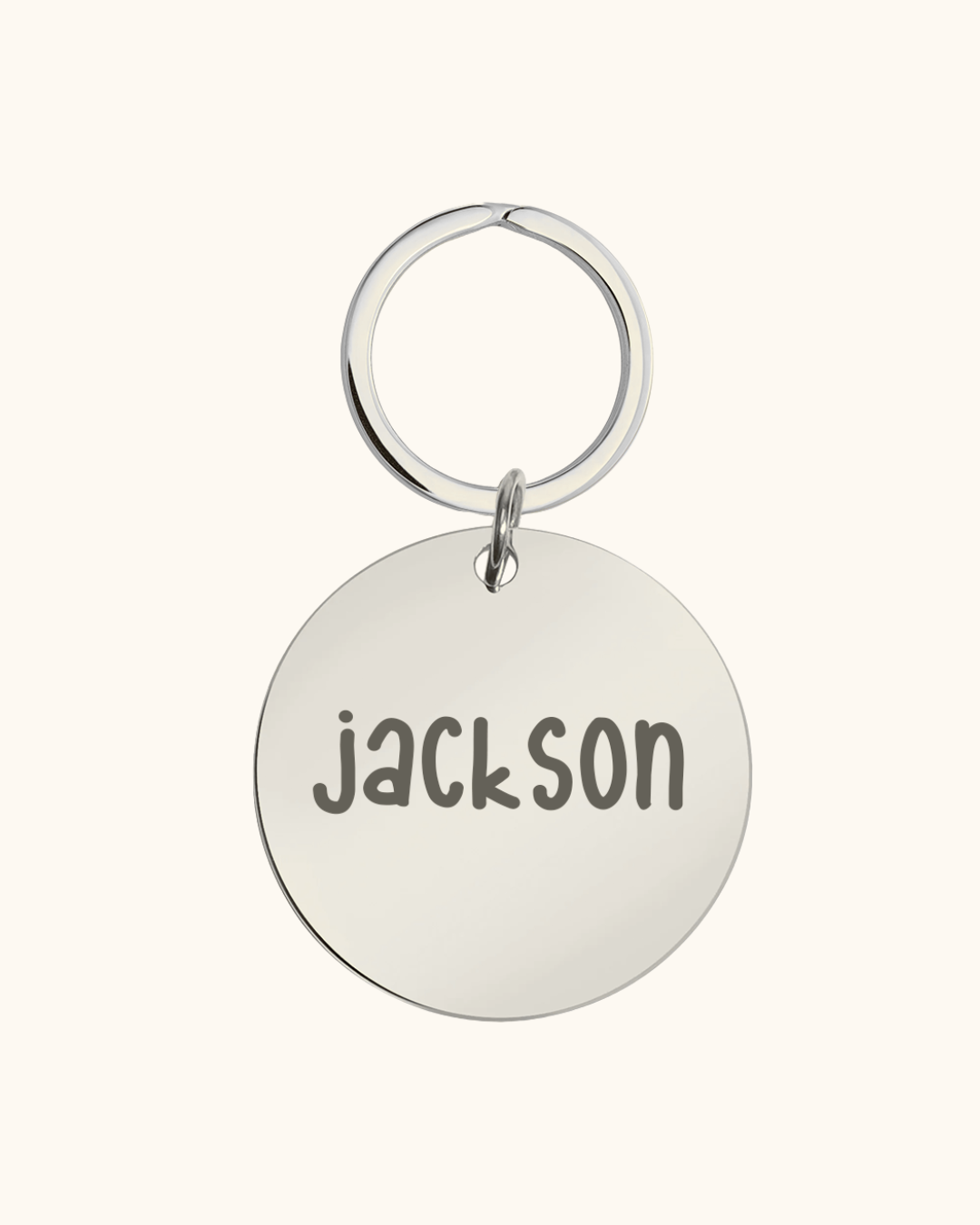 Silver dog tag with 'Jackson' engraved on a white background