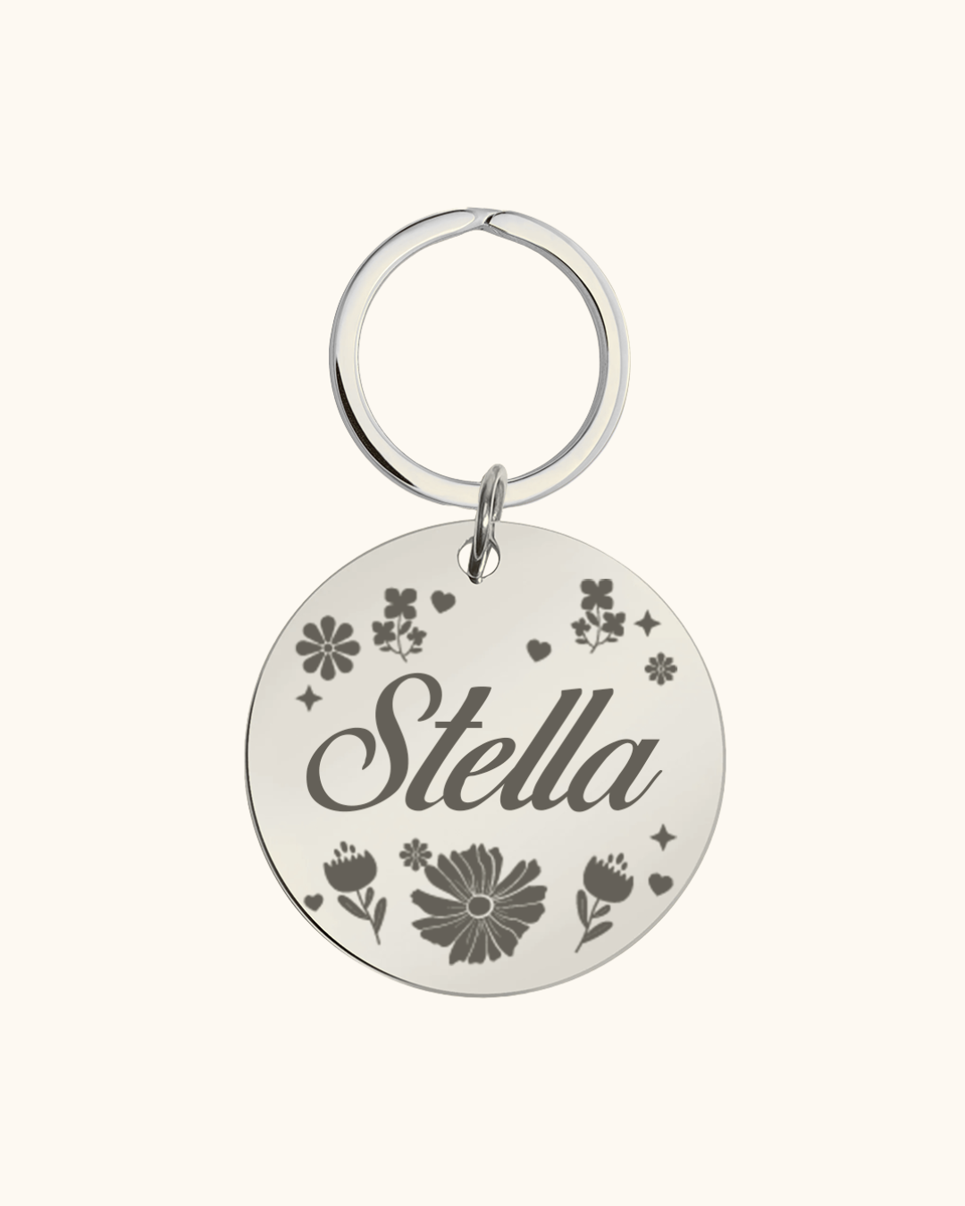 Silver pet tag with 'Stella' engraved on a white background