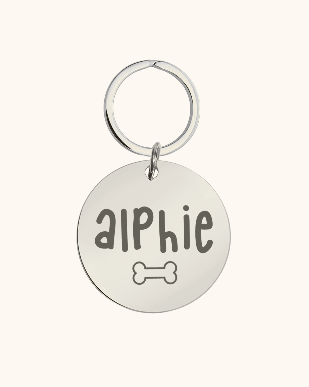 Silver pet tag with 'aIphie' engraved on a white background