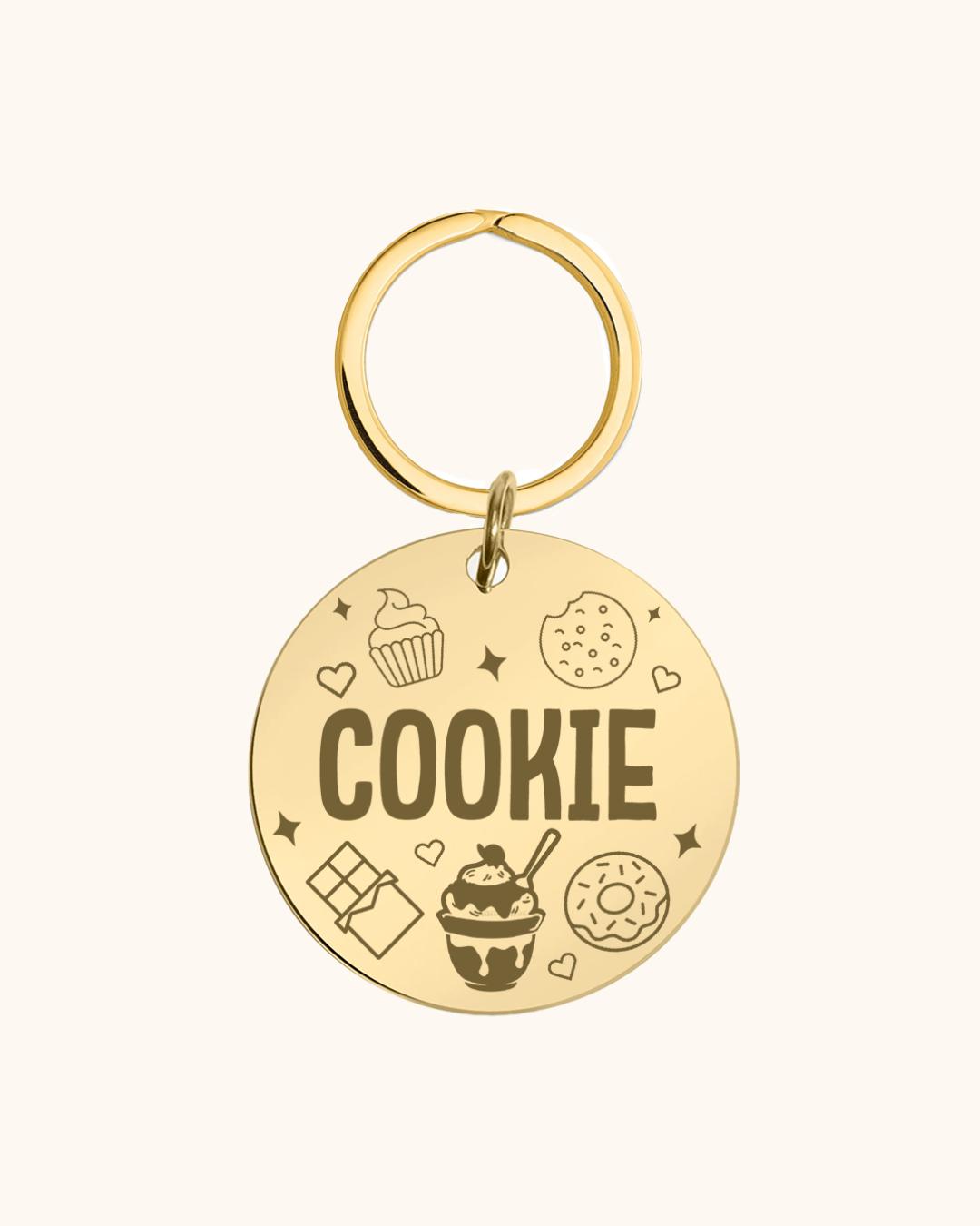 Gold pet tag with 'COOKIE' text and various icons on a white background